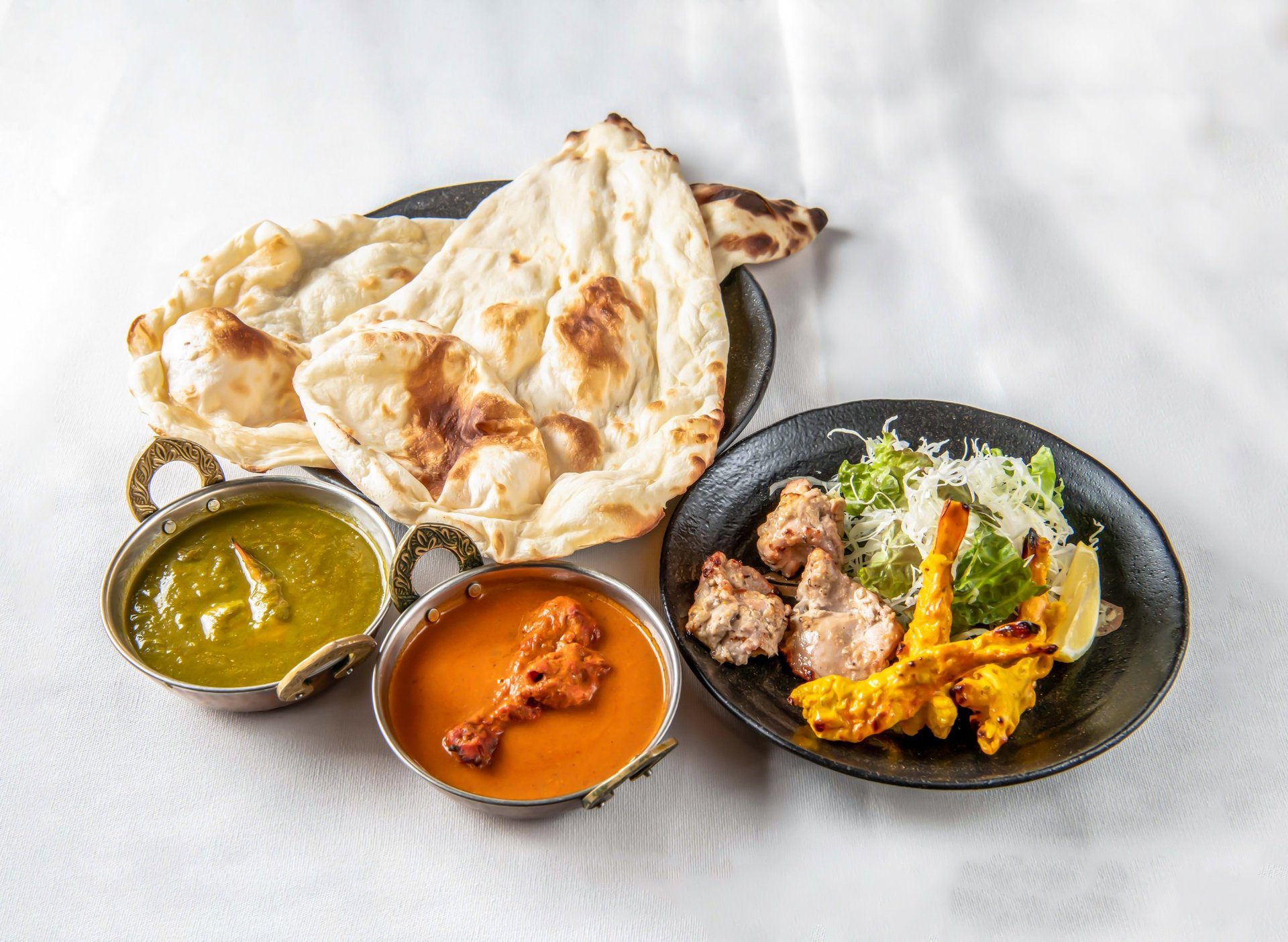 Authentic Indian cuisine spread with naan, curry, and tandoori chicken
